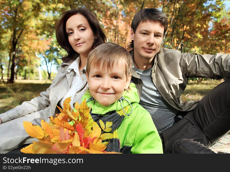 Happy family walking at the autumn park. Happy family walking at the autumn park.