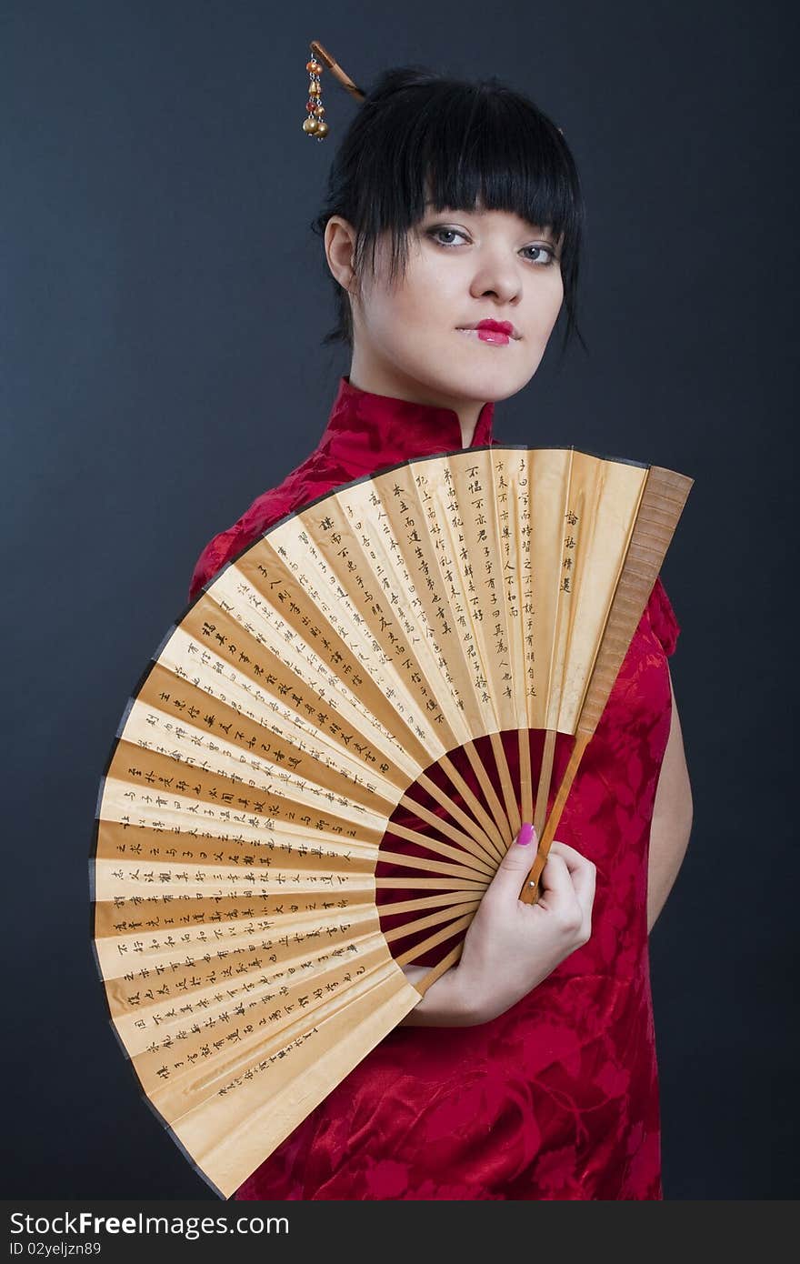 Portrait of girl in geisha costume on black background