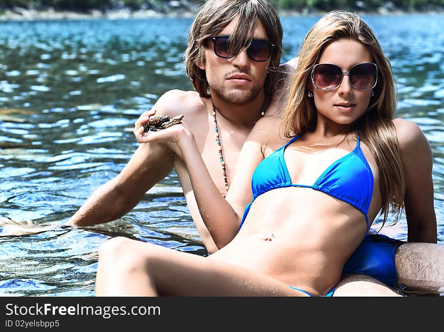 Happy young couple having a rest on a beach. Happy young couple having a rest on a beach.