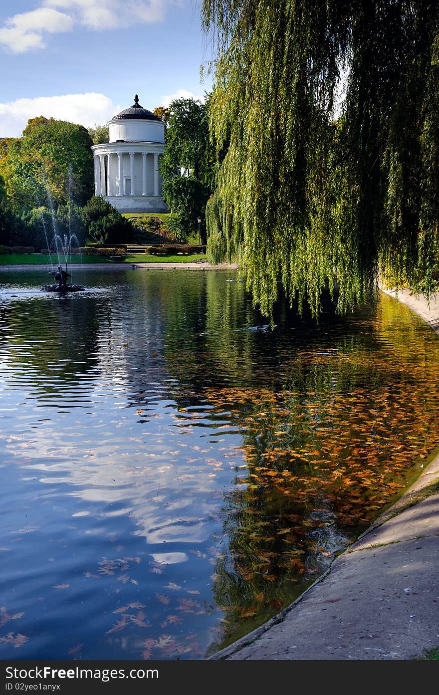 Autumn park landscape with temple and fontain