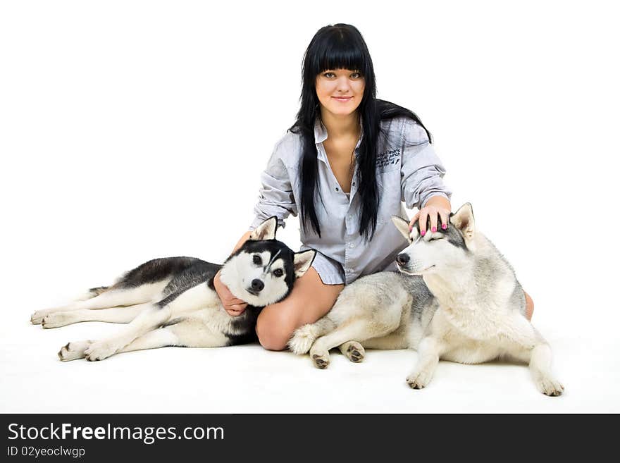 Cute girl with two siberian husky isolated on white