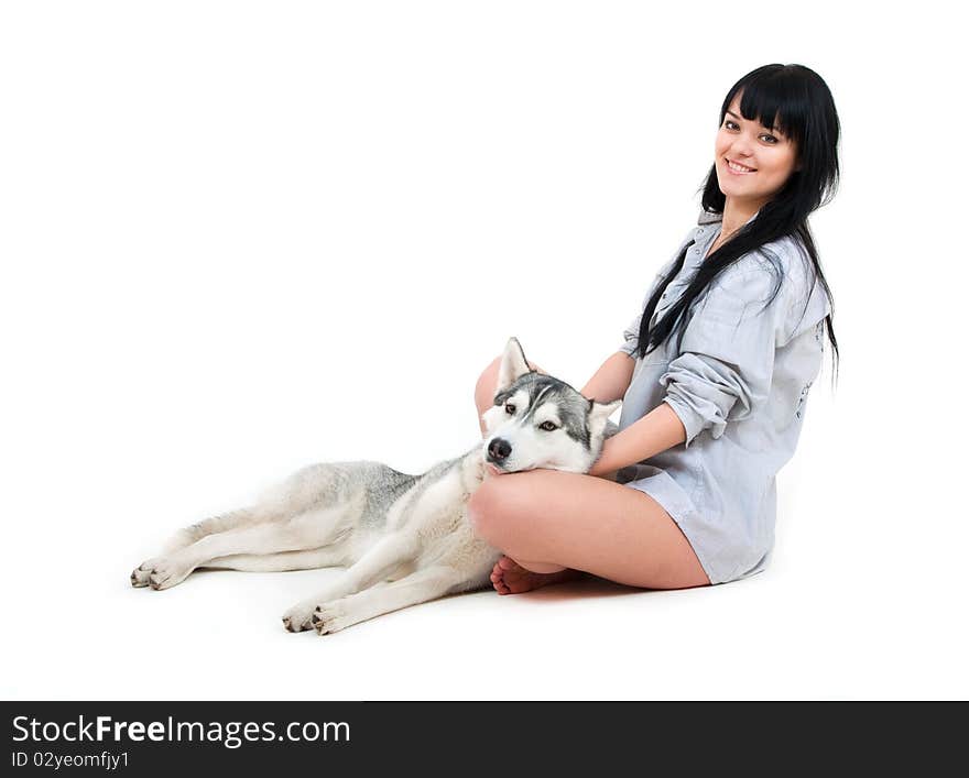 Cute girl with grey siberian husky isolated on white