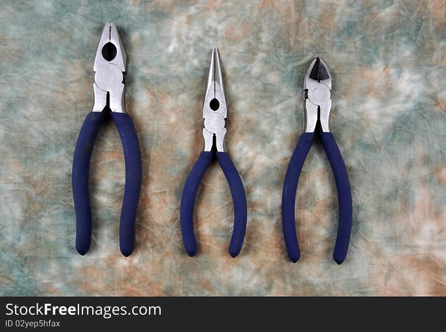 A combination pliers, long nose pliers and side cutter, photographed in a studio. A combination pliers, long nose pliers and side cutter, photographed in a studio.