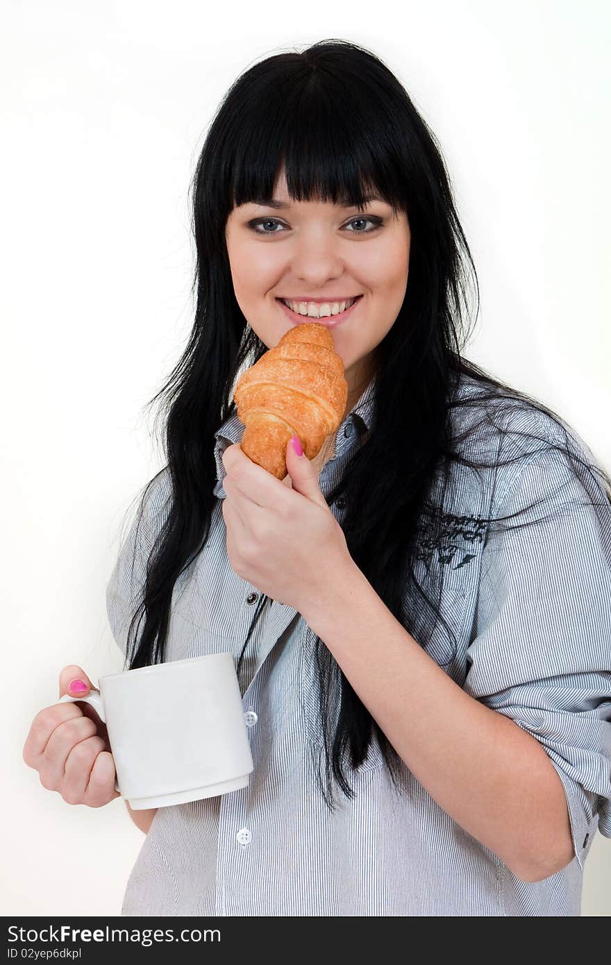 Cute girl with cup and croissant in shirt isolated on white