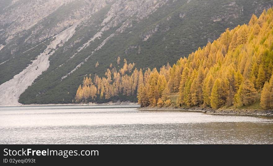 An autumn mountain lake panorama in Livigno, Valtellima, Italy