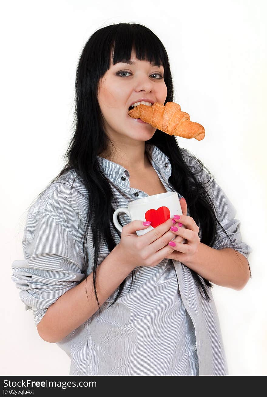 Cute girl with cup and croissant in shirt isolated on white