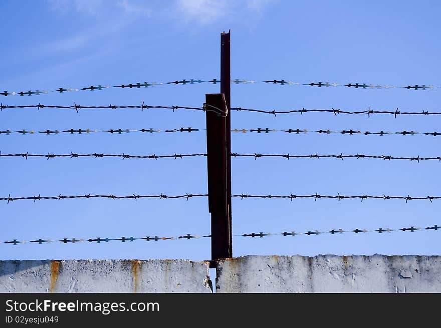 Barbed wire against the sky