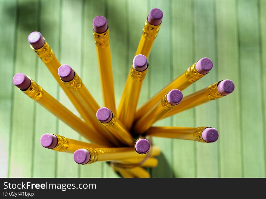 Yellow pencils tied together on a green table