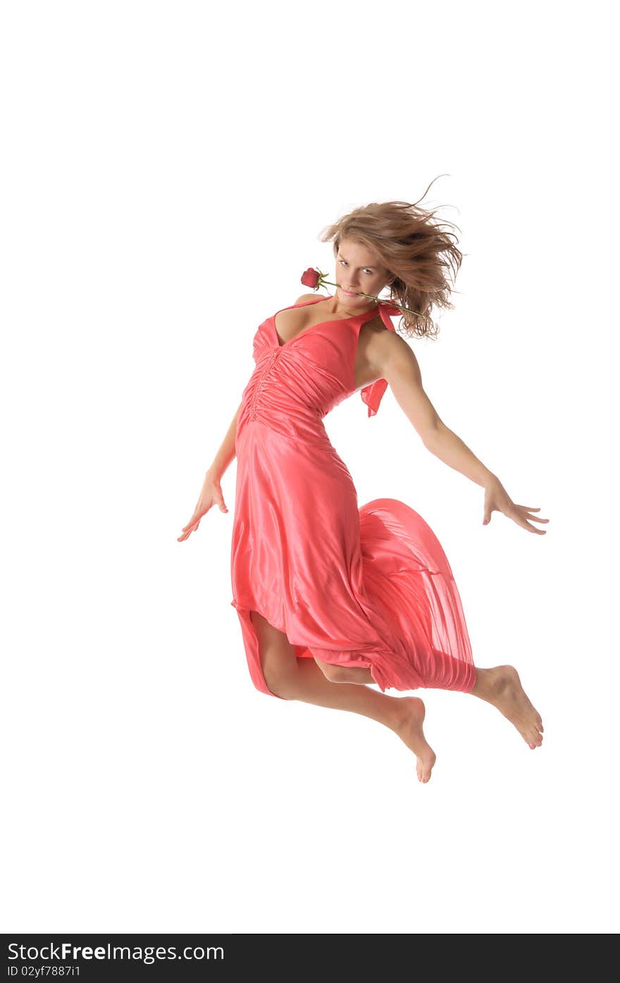 Beautiful young woman with flower jumps isolated in white