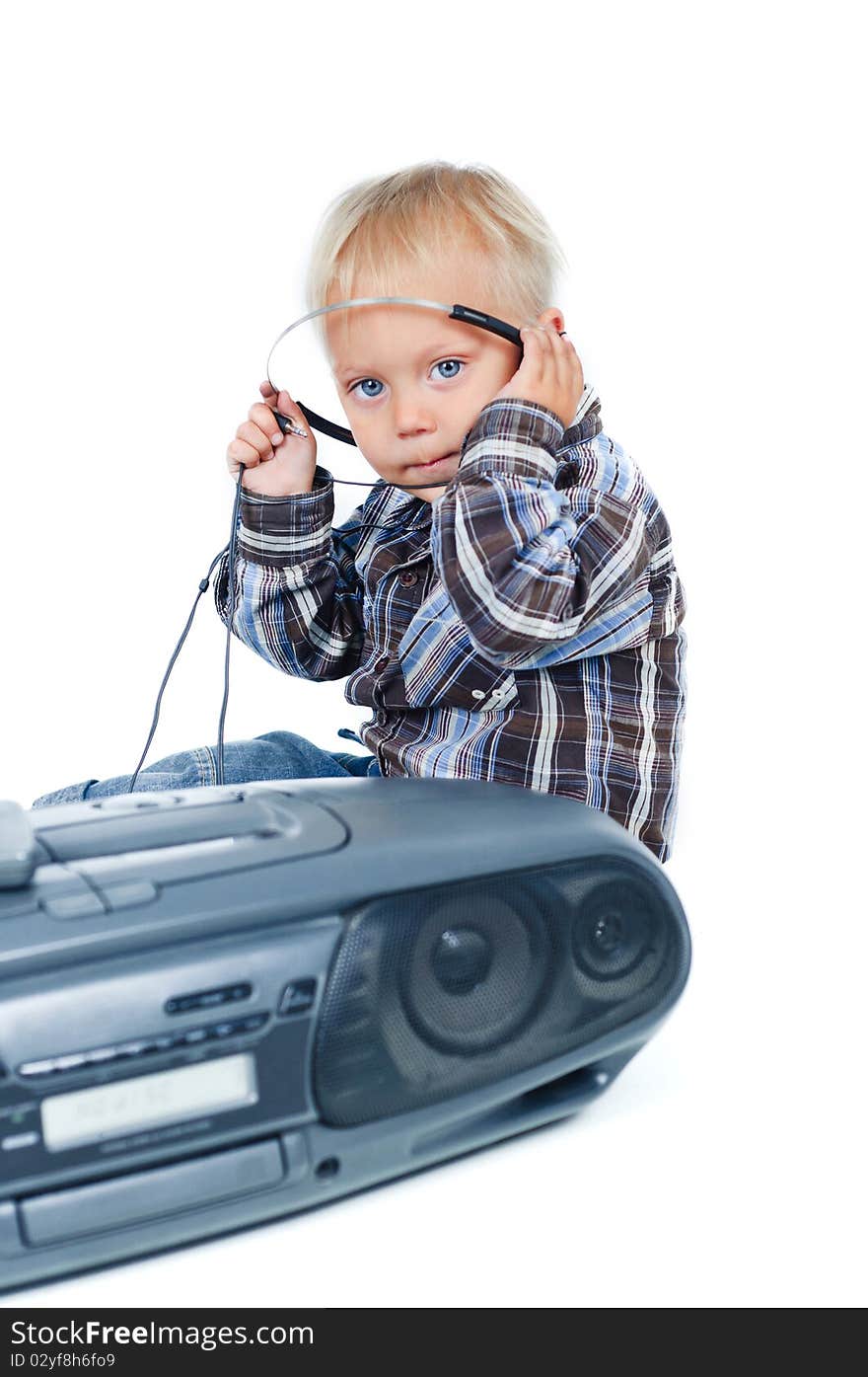 Little cute boy listens to the music. In the studio