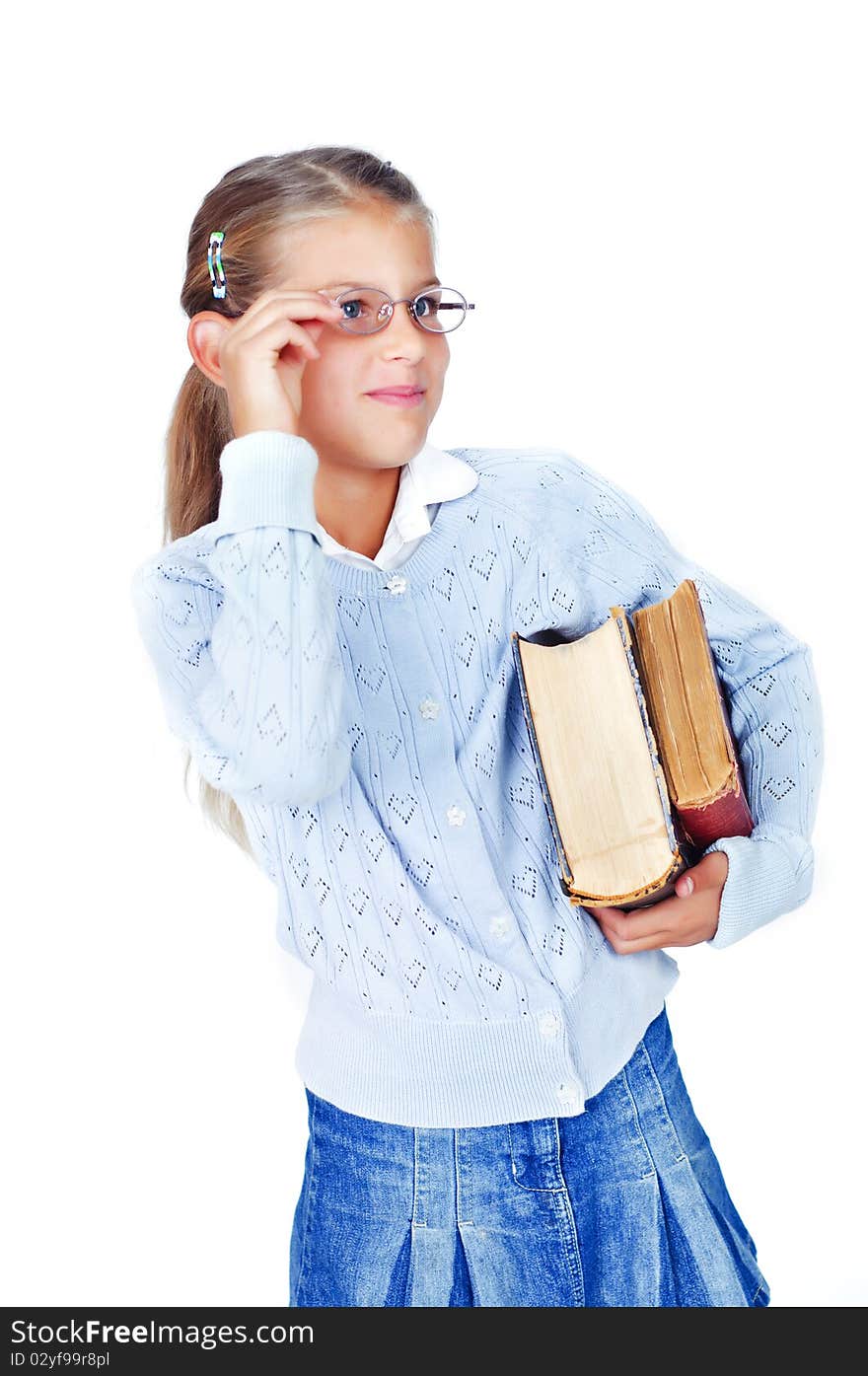 Beautiful schoolgirl in glasses with books. In the studio