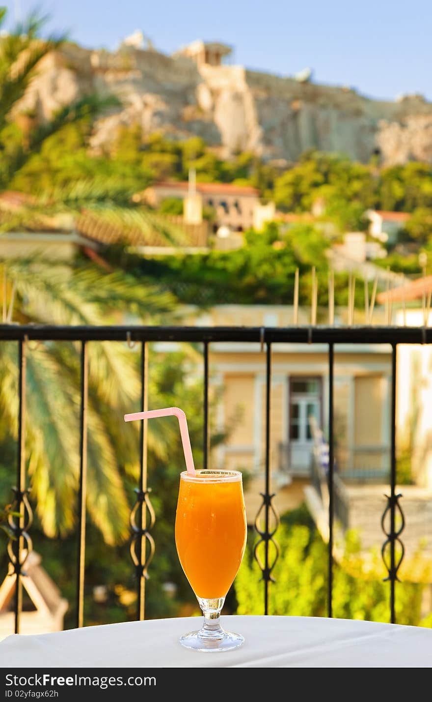 Cocktail on table in cafe - Acropolis and Athens on background