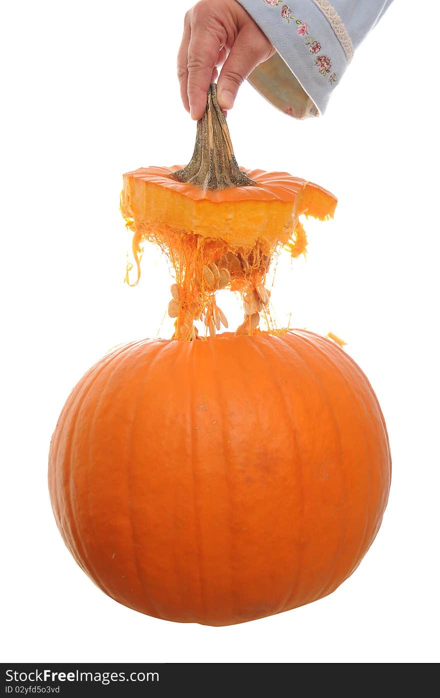 Orange pumpkin isolated on a white background with its top floating above it in mid air. Orange pumpkin isolated on a white background with its top floating above it in mid air.