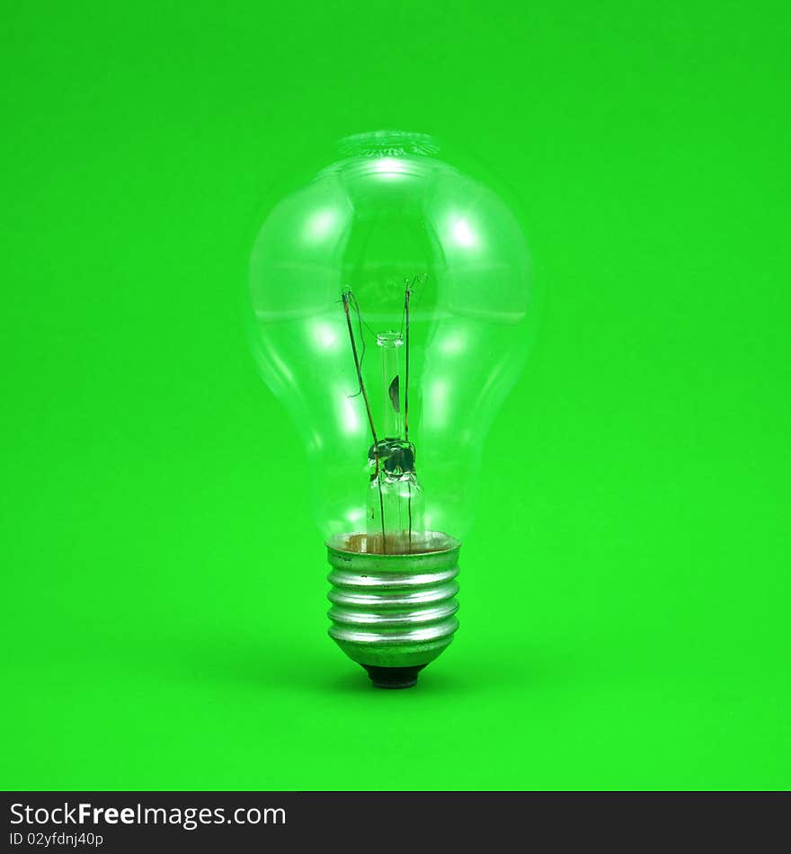 Compact light bulb isolated on green background. Compact light bulb isolated on green background