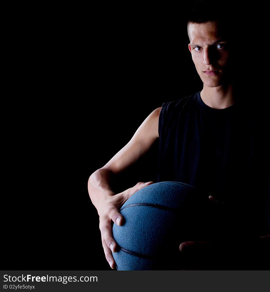 Young teenage basketball player in a studio setting with hip athletic clothing. Young teenage basketball player in a studio setting with hip athletic clothing.