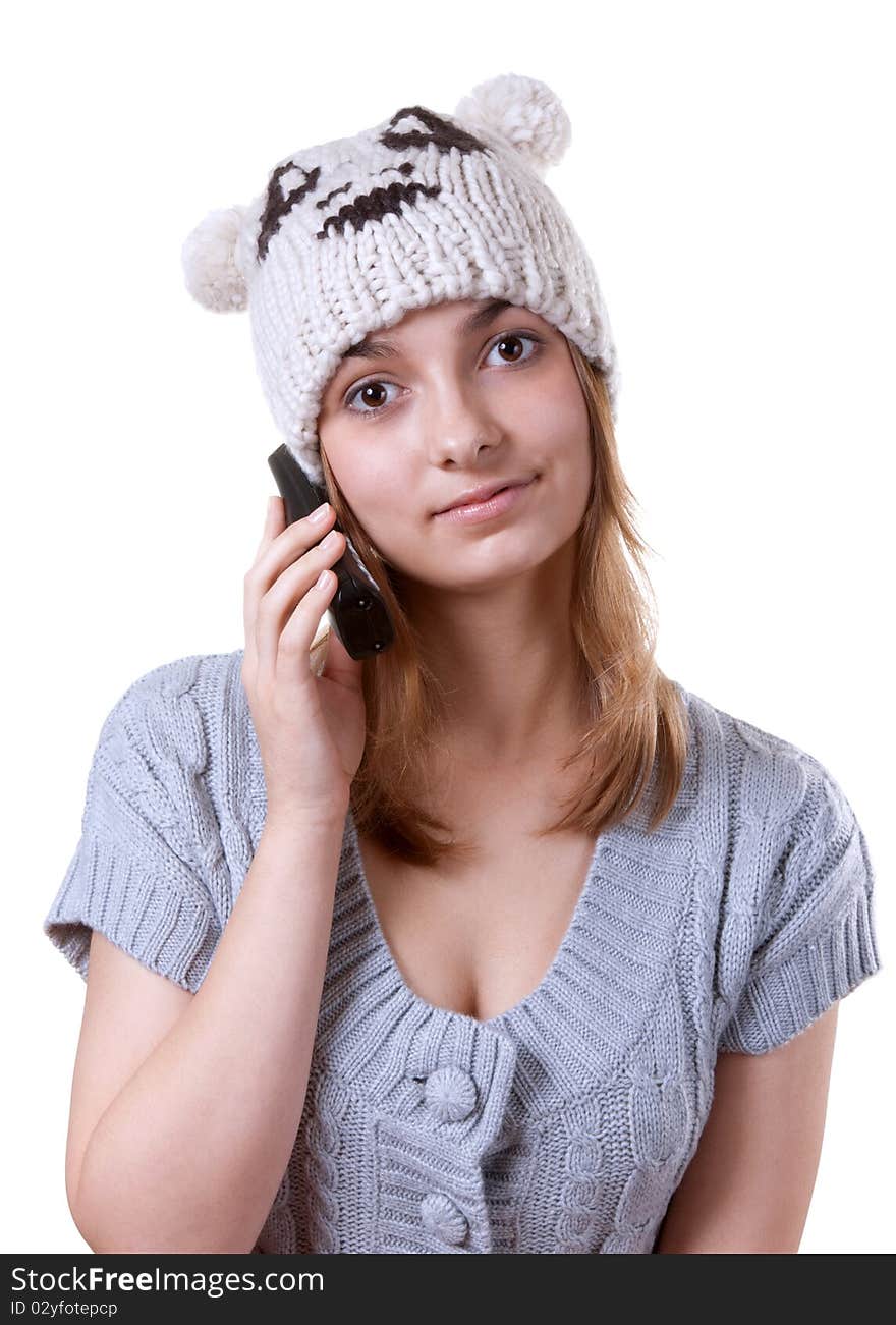 Beautiful girl in winter hat with telephone