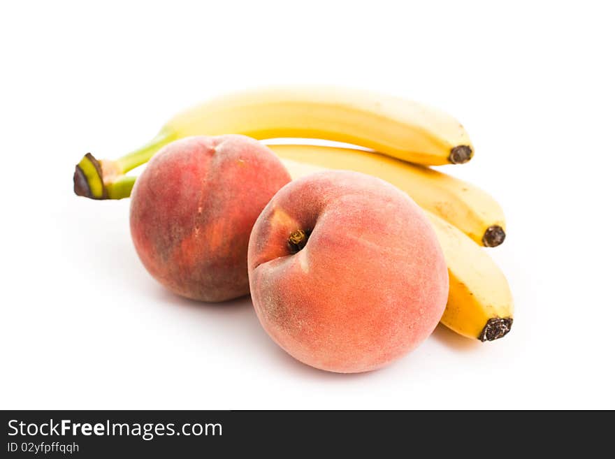 Peaches and bananas isolated on white - vegeterian healthy food