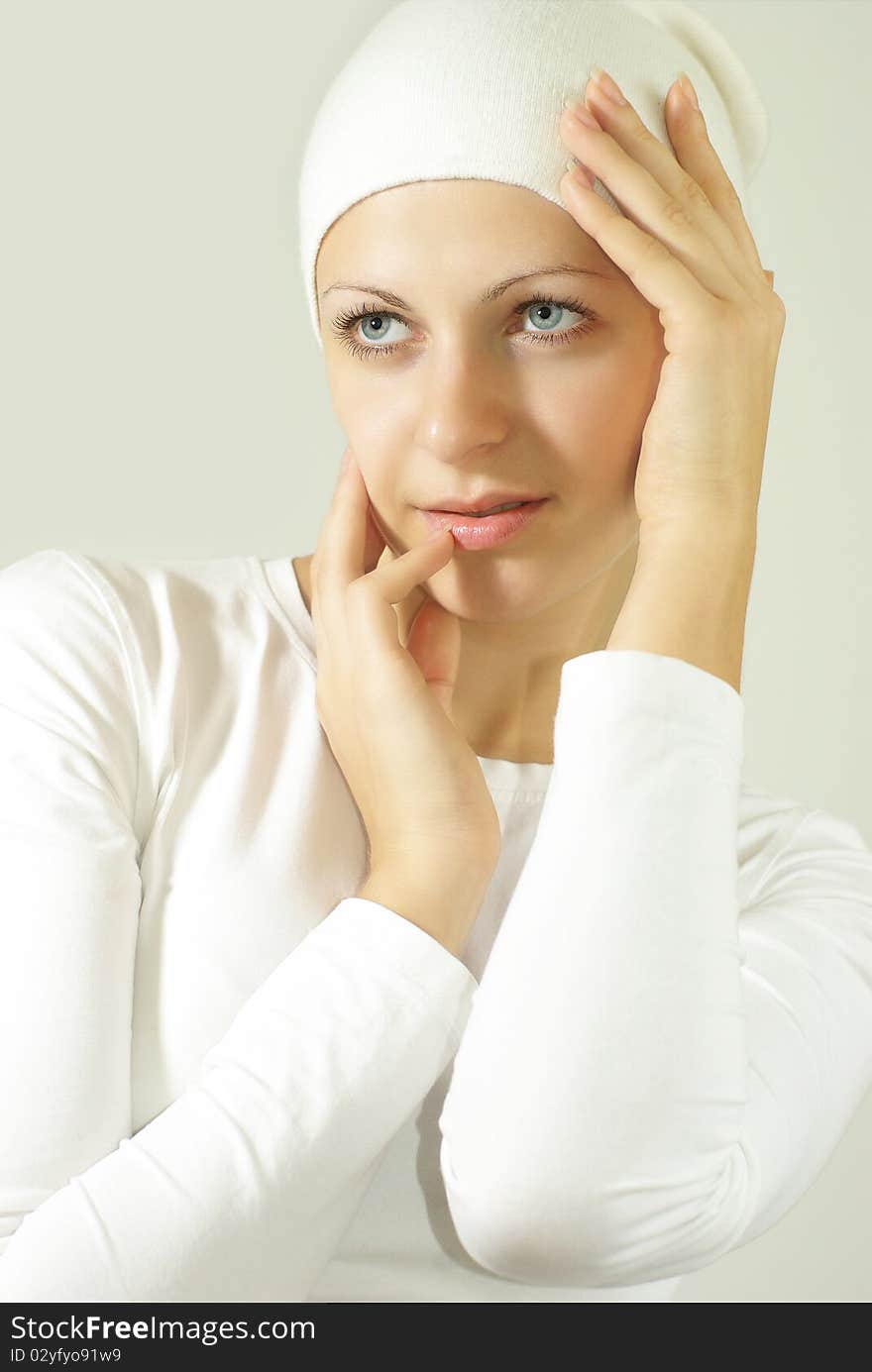 Attrective girl posing against grey wall