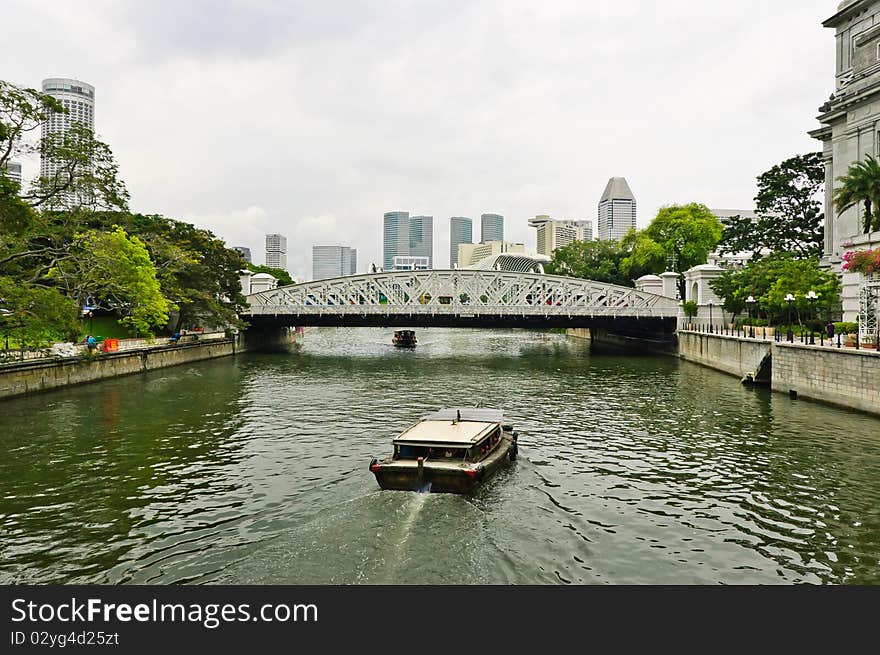 Touring boats approaching a bridge on the Singapore River, Singapore. Touring boats approaching a bridge on the Singapore River, Singapore