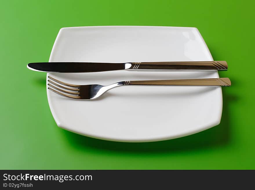 White square plate, knife, and fork