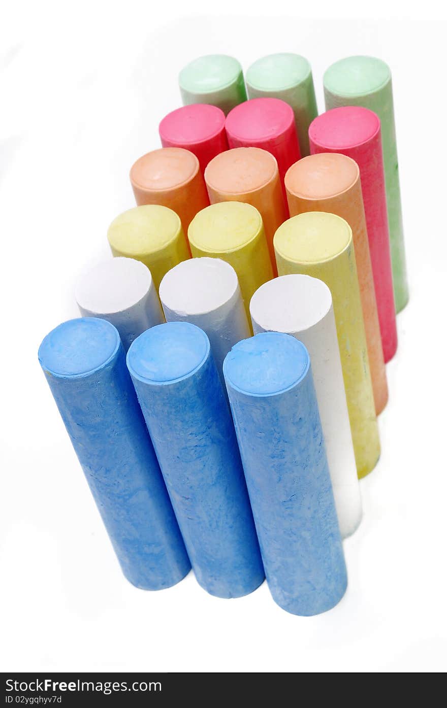 Multicolored chalk sticks on white background