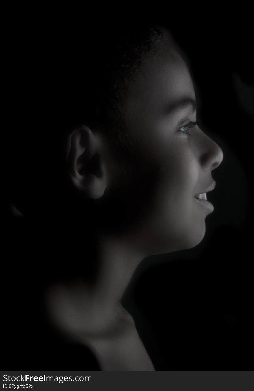 Side portrait of young teenage boy on black. Side portrait of young teenage boy on black