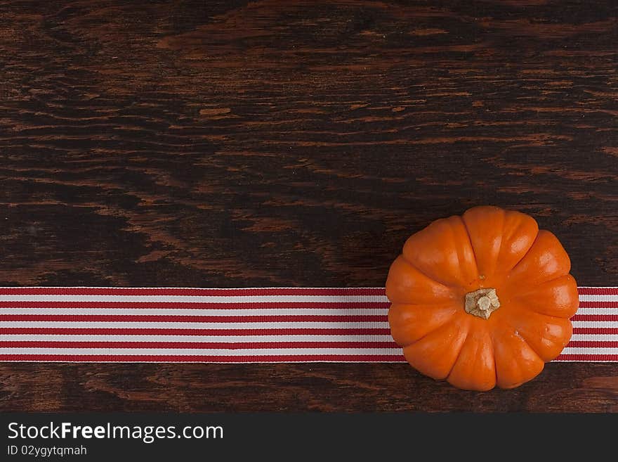 Small orange pumpkins symbolising autumn holidays and used in decorative works.