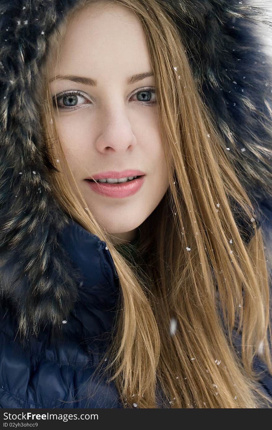 Smiling young woman in blue coat outdoors. Smiling young woman in blue coat outdoors