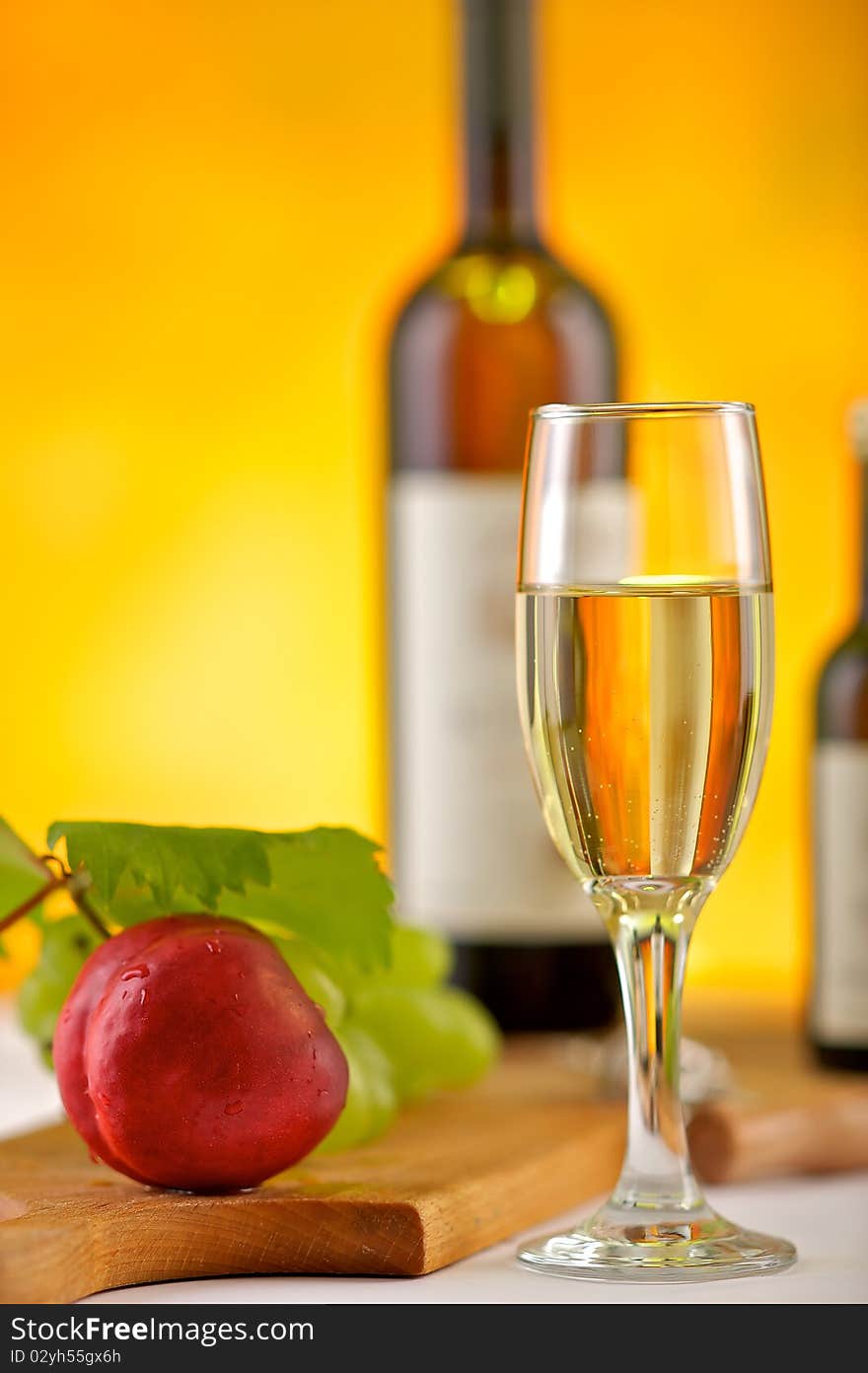 Still-life with white wine, glass, grapes, leaf and peach. Still-life with white wine, glass, grapes, leaf and peach