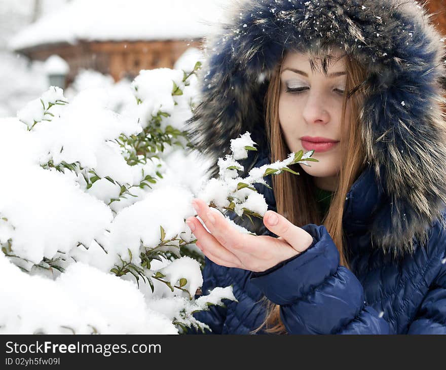 Smiling young woman in blue coat outdoors. Smiling young woman in blue coat outdoors