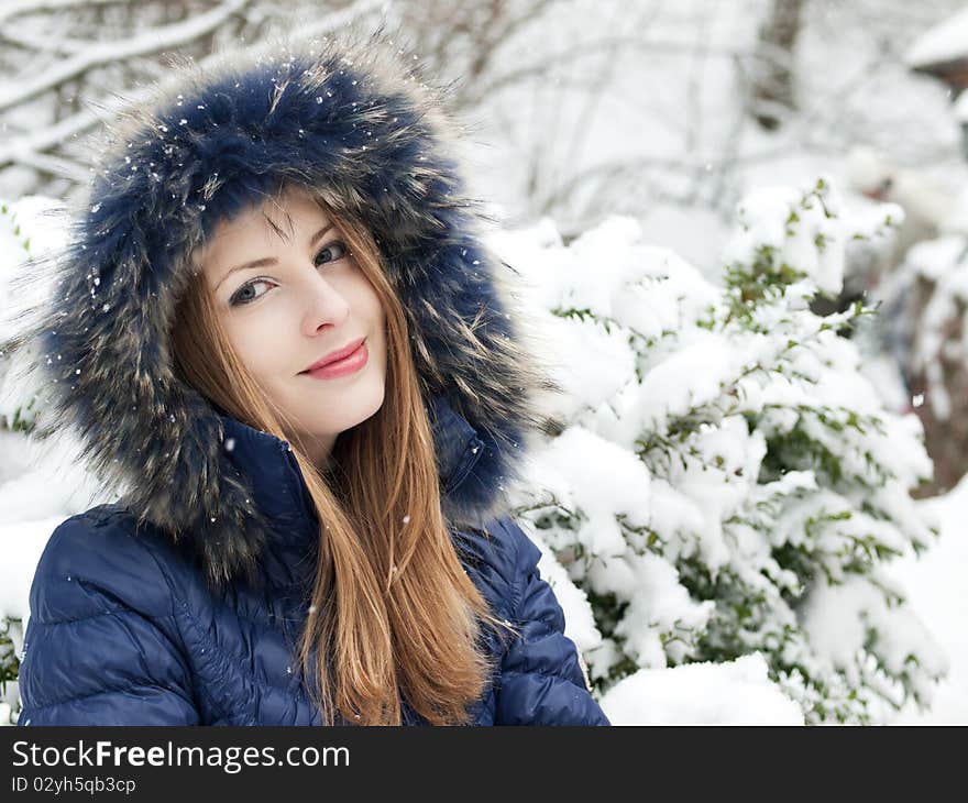 Smiling young woman in blue coat outdoors. Smiling young woman in blue coat outdoors