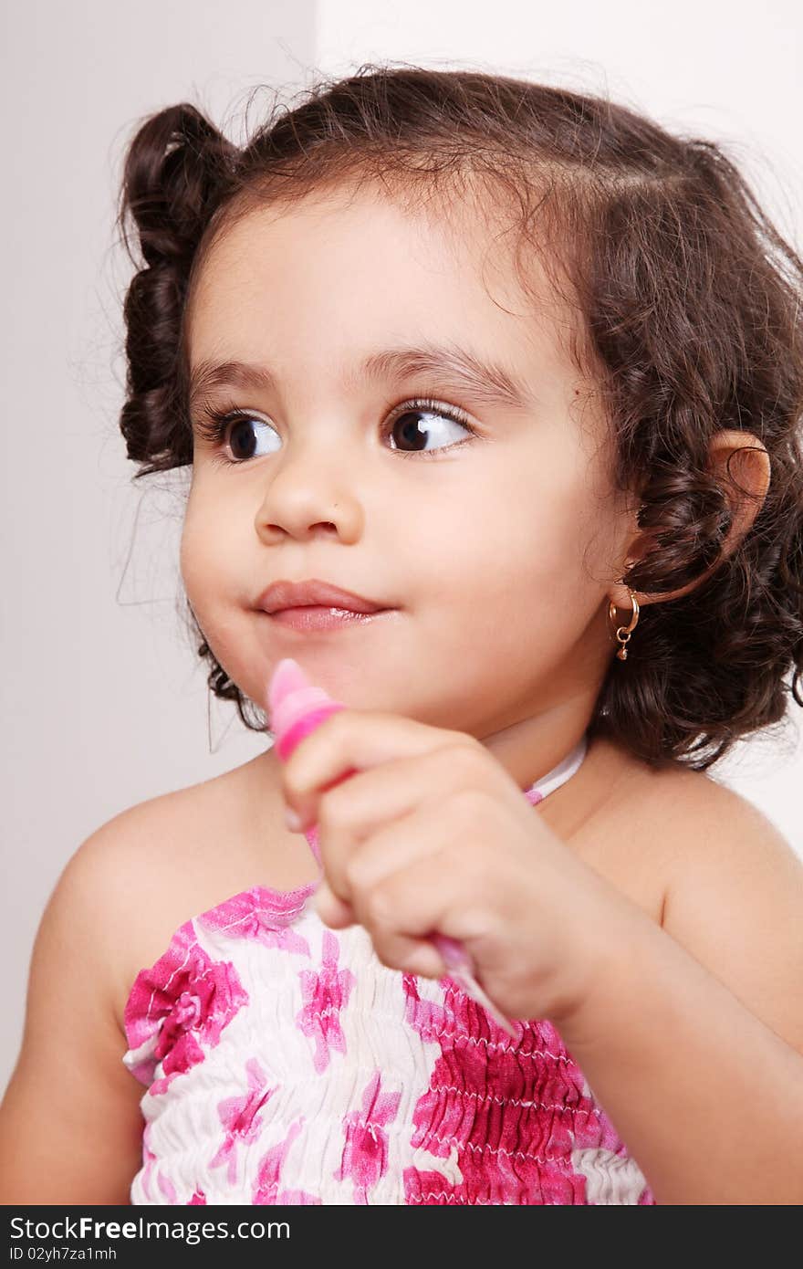 Two year old girl playing with lipstick. Two year old girl playing with lipstick