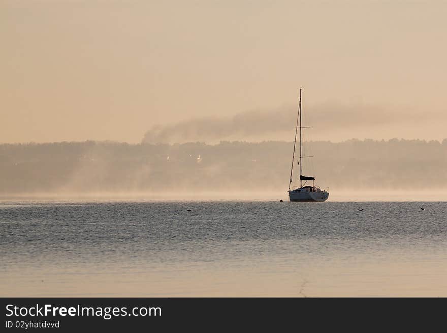 Sunrise over lake with boat. Sunrise over lake with boat