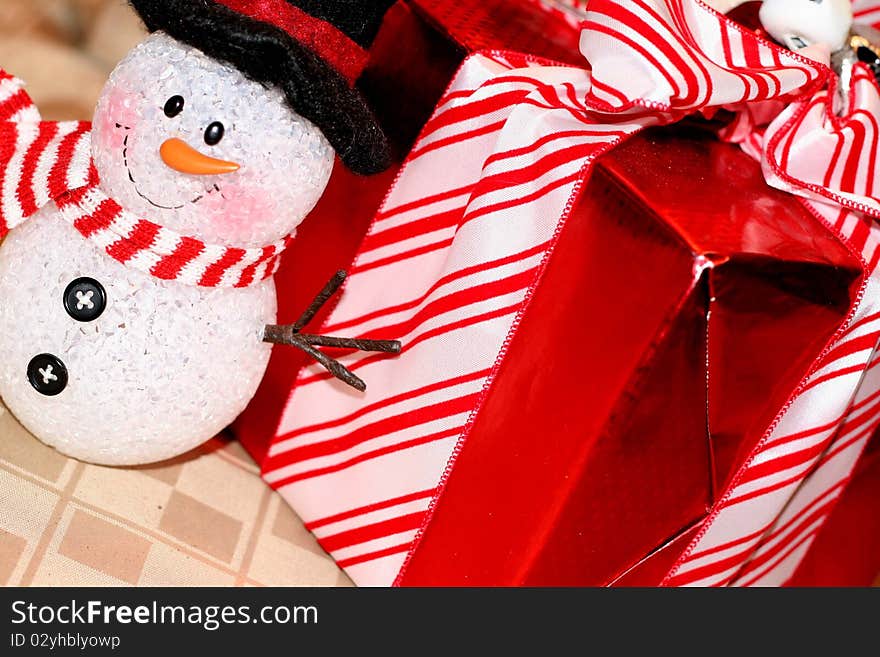 Snowman decoration with red wrapped gift. Snowman decoration with red wrapped gift