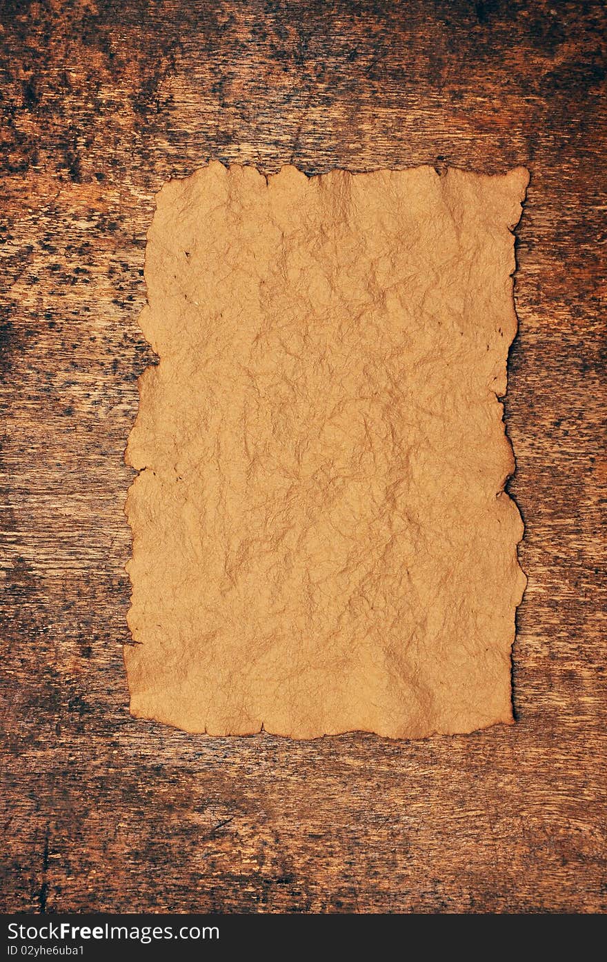 Vintage old paper on grungy wood background