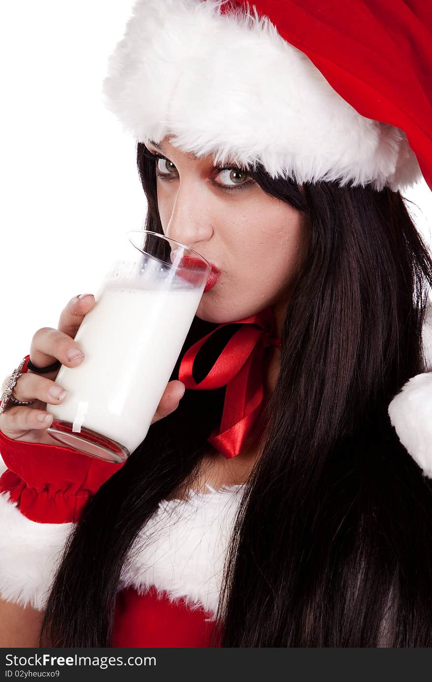 A woman dressed in a santa out fit drinking milk. A woman dressed in a santa out fit drinking milk.