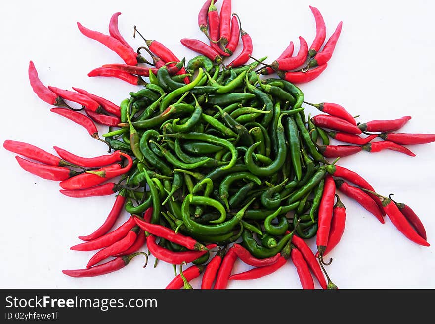 Sun shape made of gren and red chili peppers. Sun shape made of gren and red chili peppers