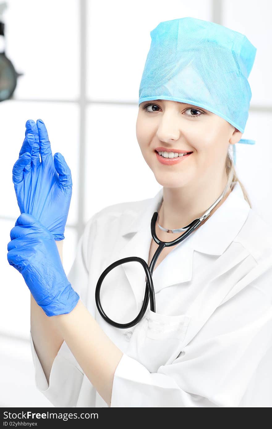 Beautiful woman doctor in uniform in cabinet