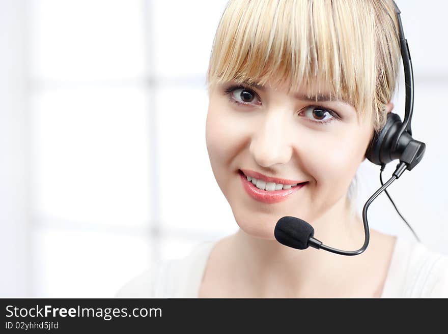 Blond beautiful woman with headphones in office. Blond beautiful woman with headphones in office