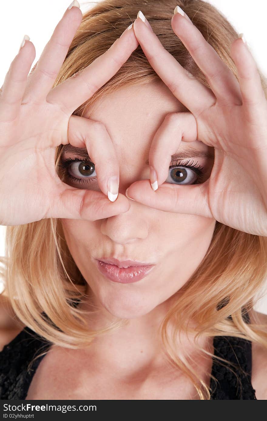 Woman looking through fingers circles