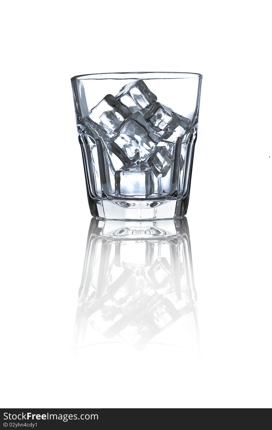 Glass with ice cubes on white background