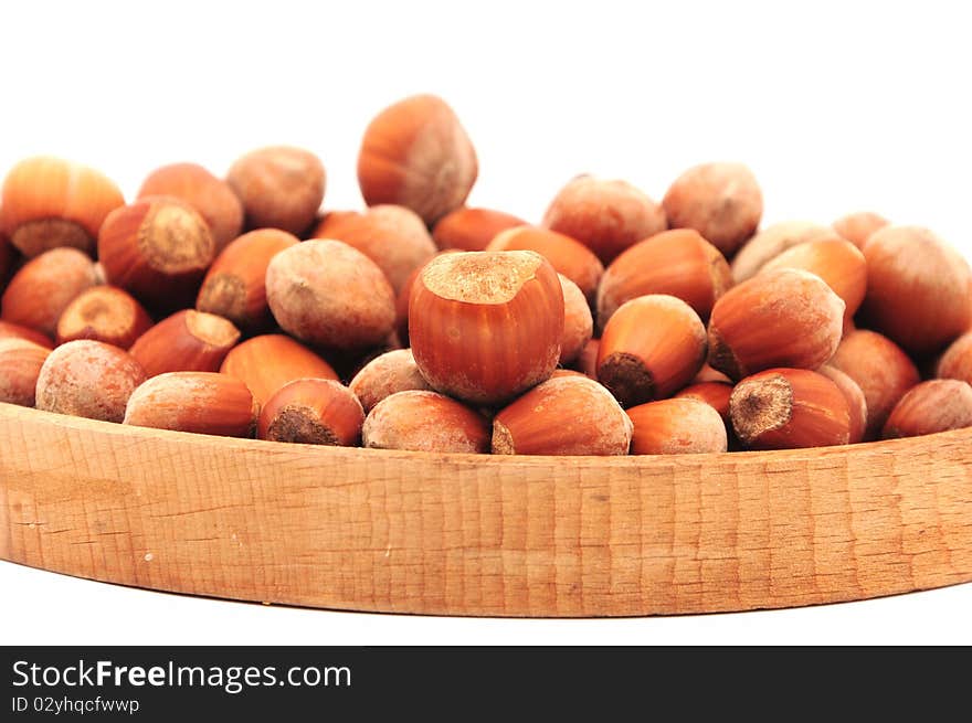 Hazelnuts on a wooden plate. Hazelnuts on a wooden plate