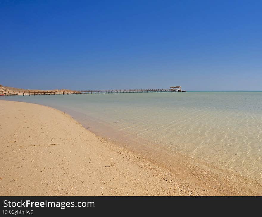 Tropical beach with a jetty