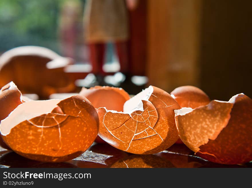 Cracked eggshells with backlight from sun through a window, cracked into interesting patterns.