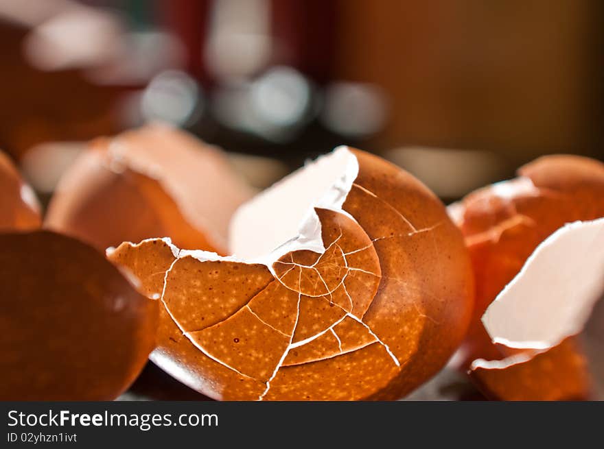 Cracked eggshells with backlight from sun through a window, cracked into interesting patterns.