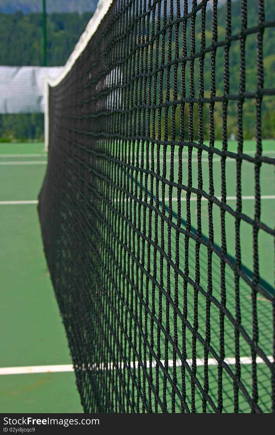 Yellow-red balls on a green tennis court. Yellow-red balls on a green tennis court