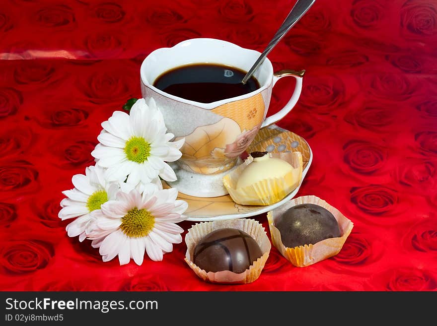 Cup of black coffee, a bouquet of roses and chocolates. Cup of black coffee, a bouquet of roses and chocolates