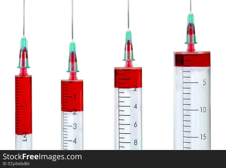 Four disposable syringe against white background