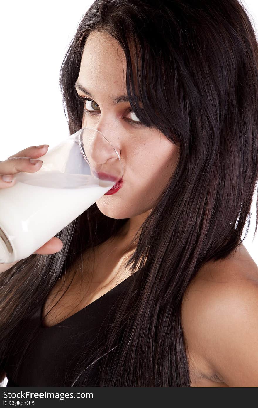 A woman is drinking a glass of milk. A woman is drinking a glass of milk.