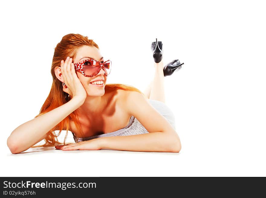 Attractive young smiling woman in grey on floor